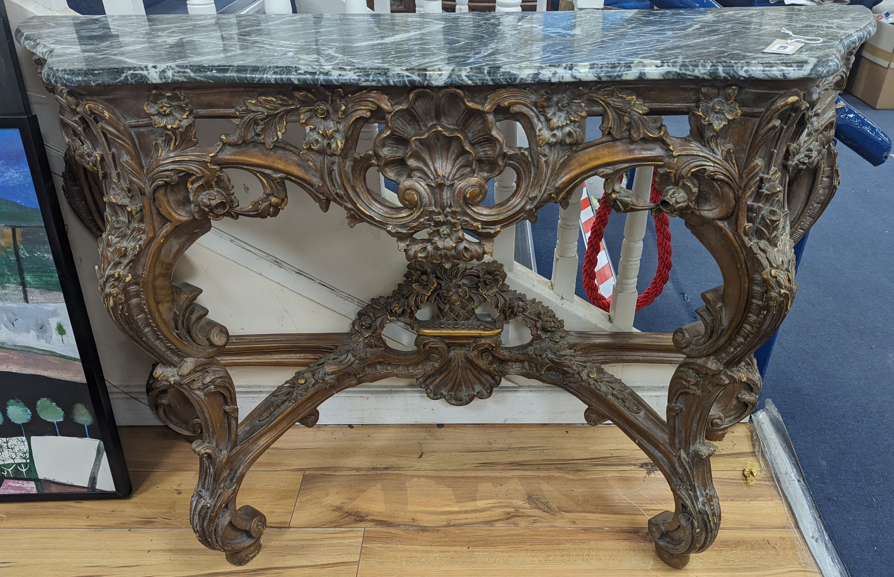 An 18th century style carved giltwood serpentine console table with serpentine marble top, width 140cm, depth 44cm, height 95cm